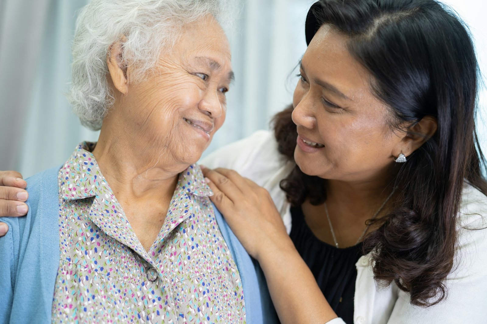 Asian elderly woman with caregiver walking with happy.